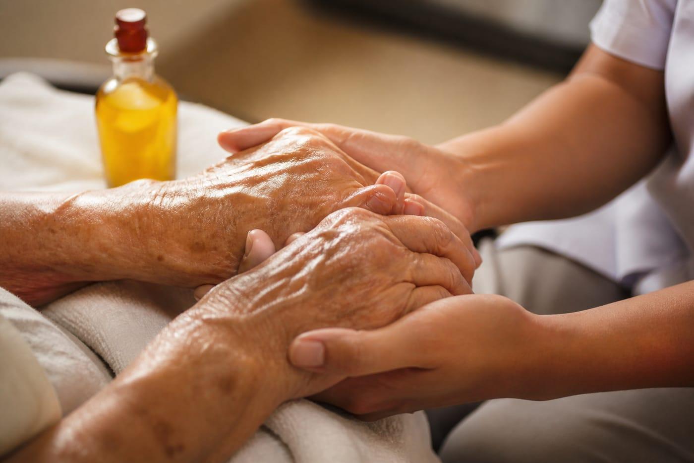 Gentle hand support in geriatric care consultation, no faces shown